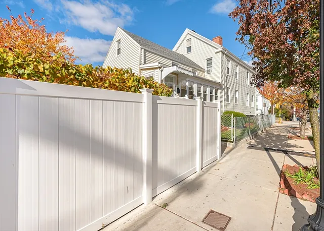 a backyard of a house with table and chairs