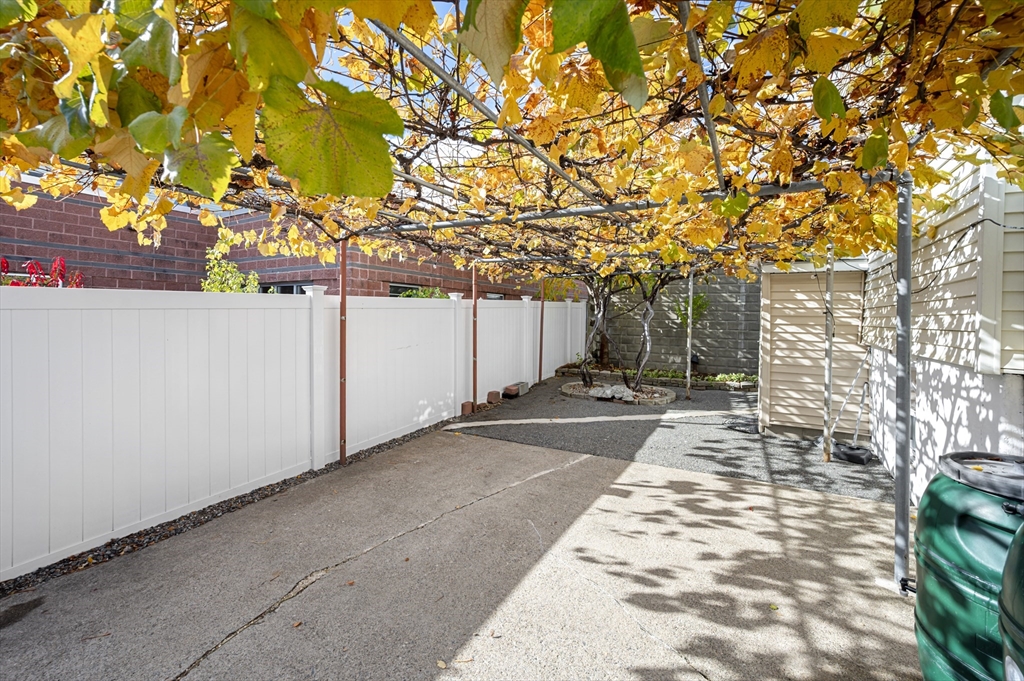 50 Temple Street, Unit 50 Somerville, MA 02145 - Photo 37 of 41 a backyard of a house with table and chairs