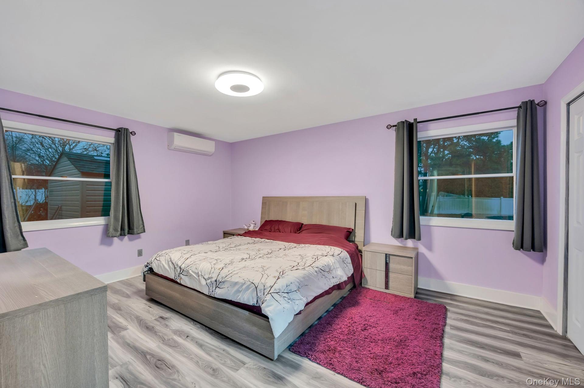 15 Drake Avenue Bellport, NY 11713 - Photo 13 of 20 a bedroom with a bed wooden floor and window