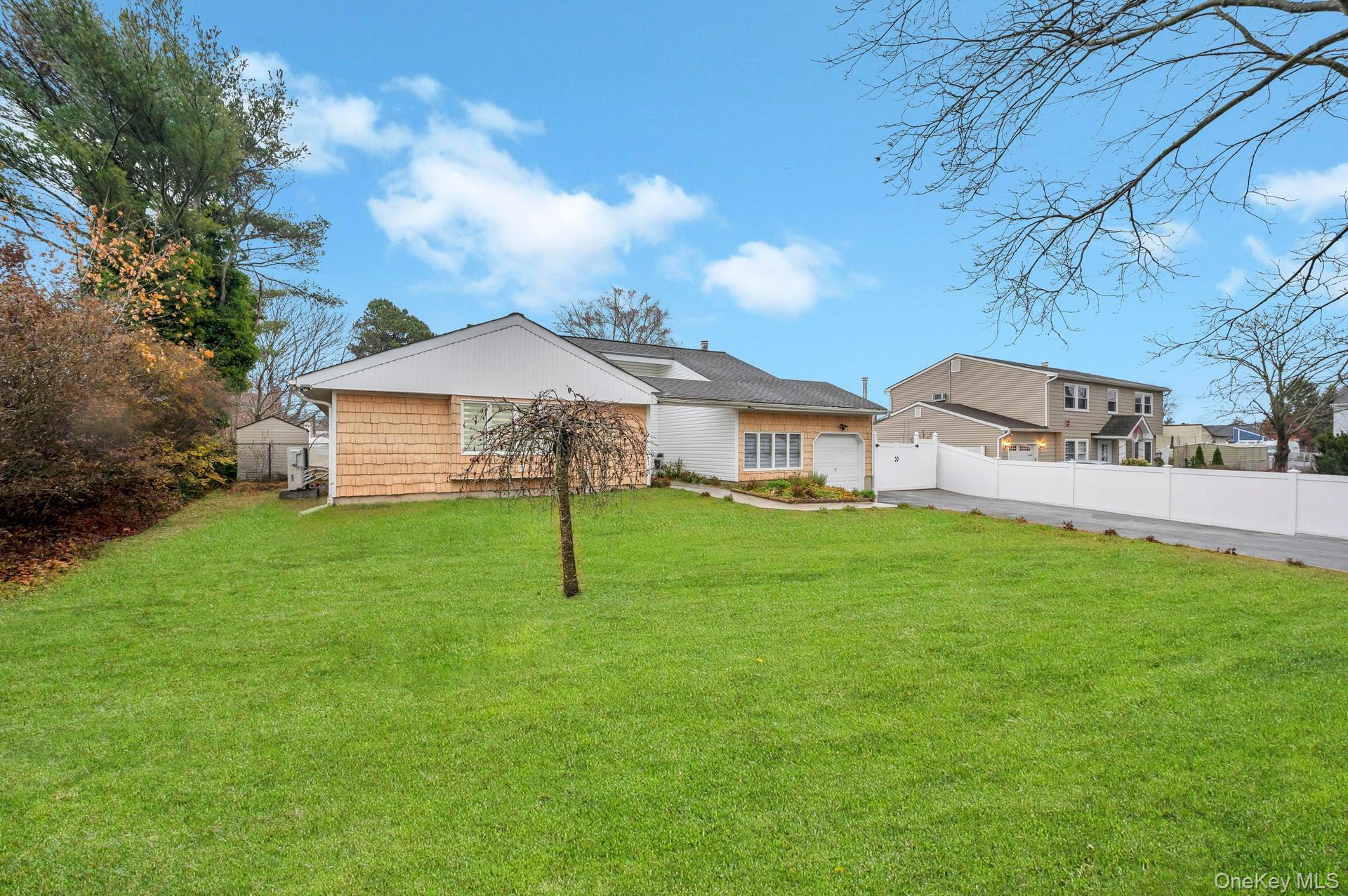 15 Drake Avenue Bellport, NY 11713 - Photo 18 of 20 a view of a house with a backyard
