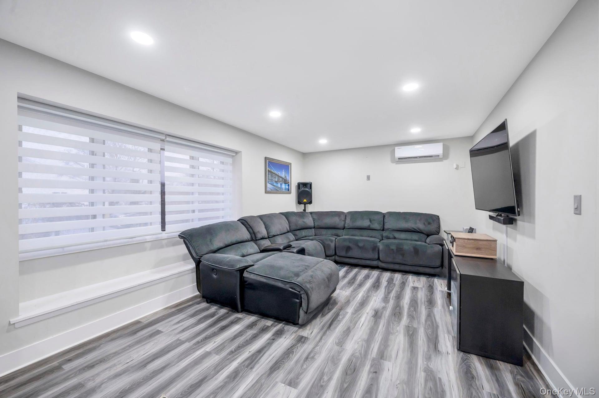 15 Drake Avenue Bellport, NY 11713 - Photo 5 of 20 a living room with furniture and a flat screen tv