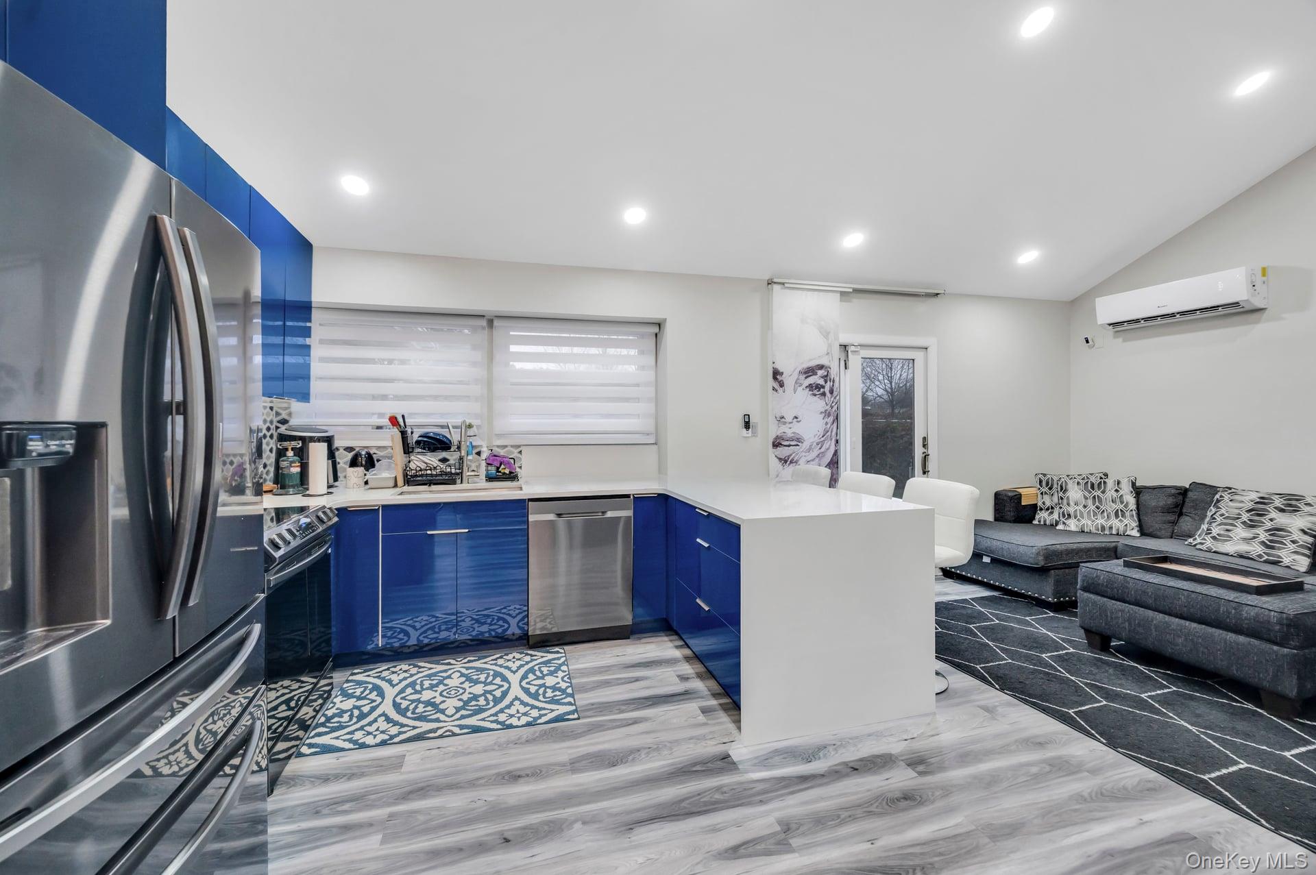 15 Drake Avenue Bellport, NY 11713 - Photo 7 of 20 a large kitchen with stainless steel appliances kitchen island granite countertop a refrigerator and a stove