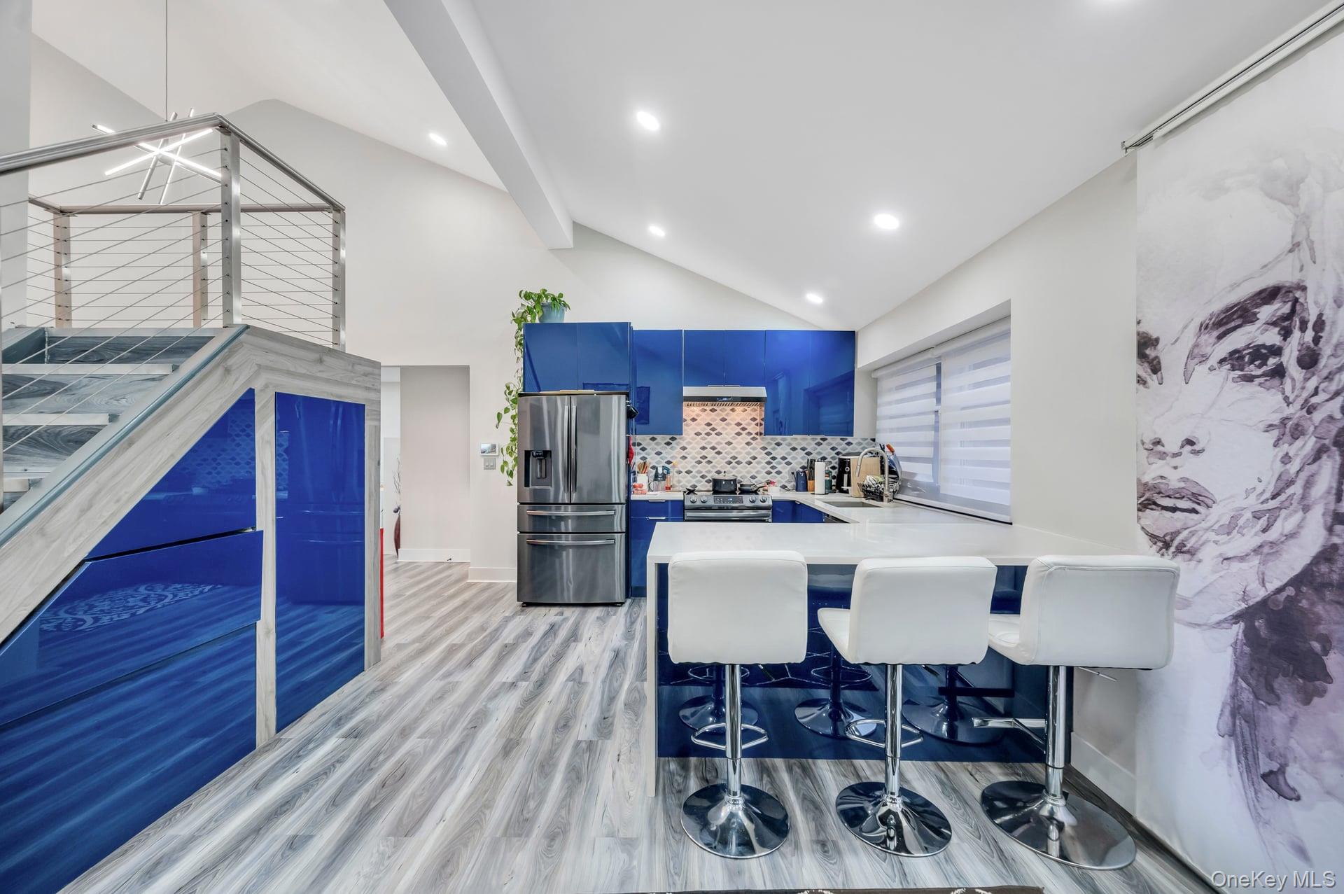 15 Drake Avenue Bellport, NY 11713 - Photo 8 of 20 a view of kitchen with stainless steel appliances granite countertop a stove top oven a chimney and a dining table with wooden floor