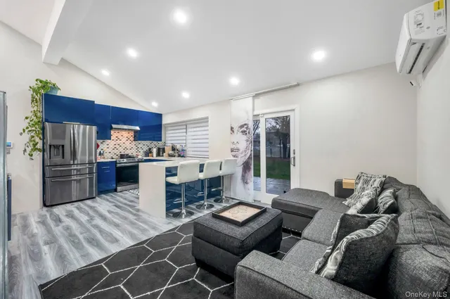 a living room with furniture and kitchen view