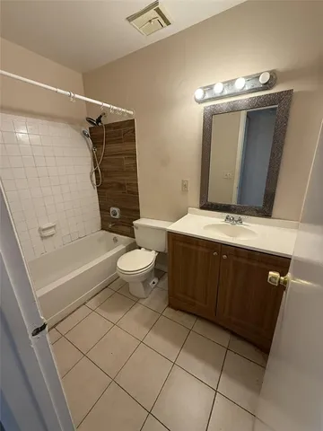 an empty room with wooden floor and a window