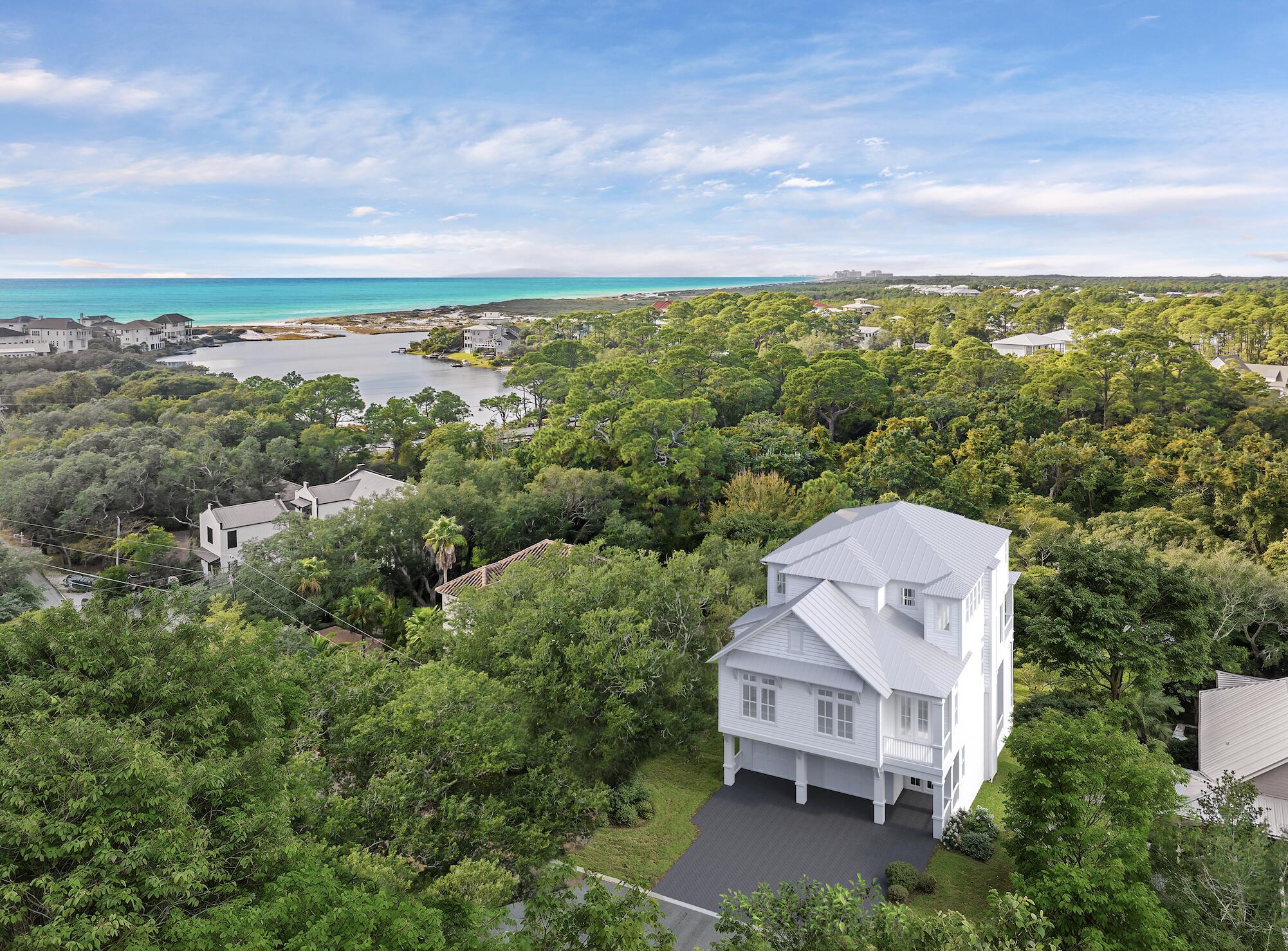 an aerial view of a house with a yard and lake view