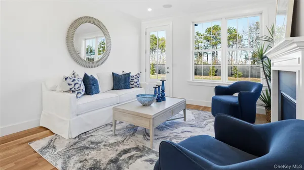 a living room with furniture a large window and a dining table