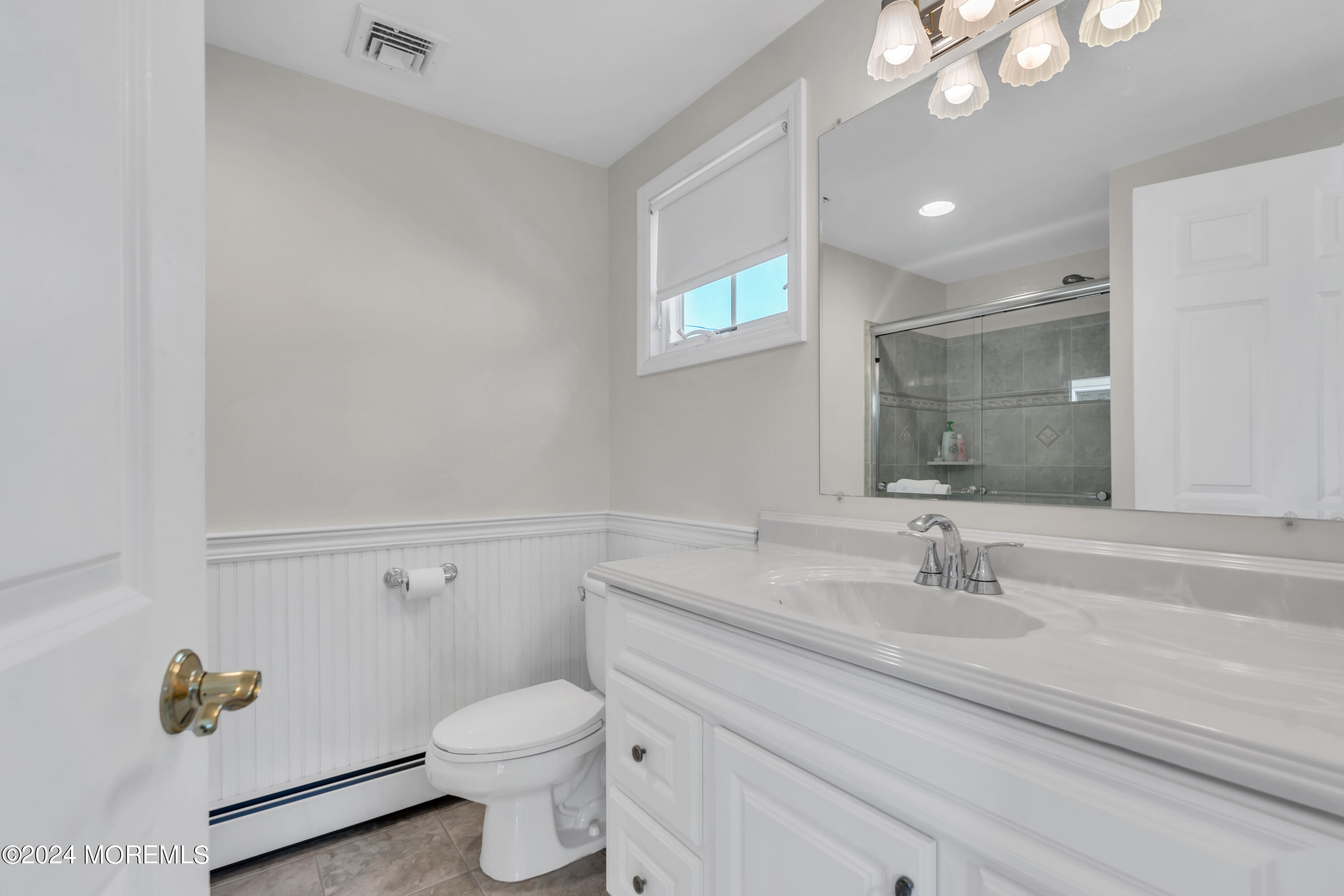 807 Prospect Avenue Spring Lake Heights, NJ 07762 - Photo 16 of 27 a bathroom with a sink a toilet and a mirror