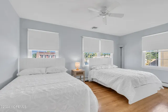 a bedroom with two beds and a chandelier