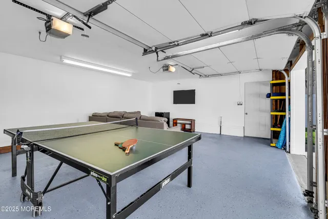 a room with pool table and windows