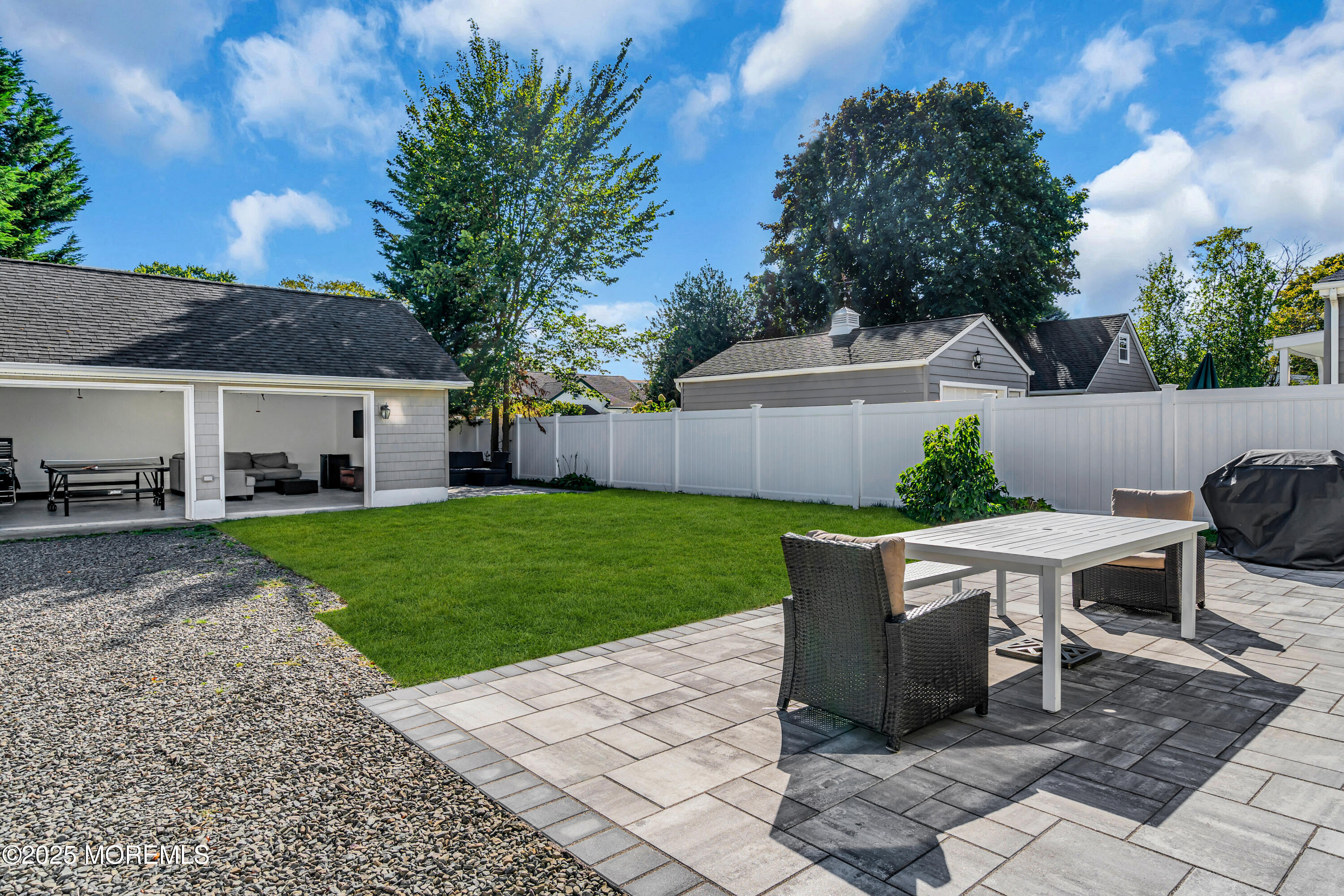 807 Prospect Avenue Spring Lake Heights, NJ 07762 - Photo 4 of 27 a view of a patio with table and chairs potted plants and large tree