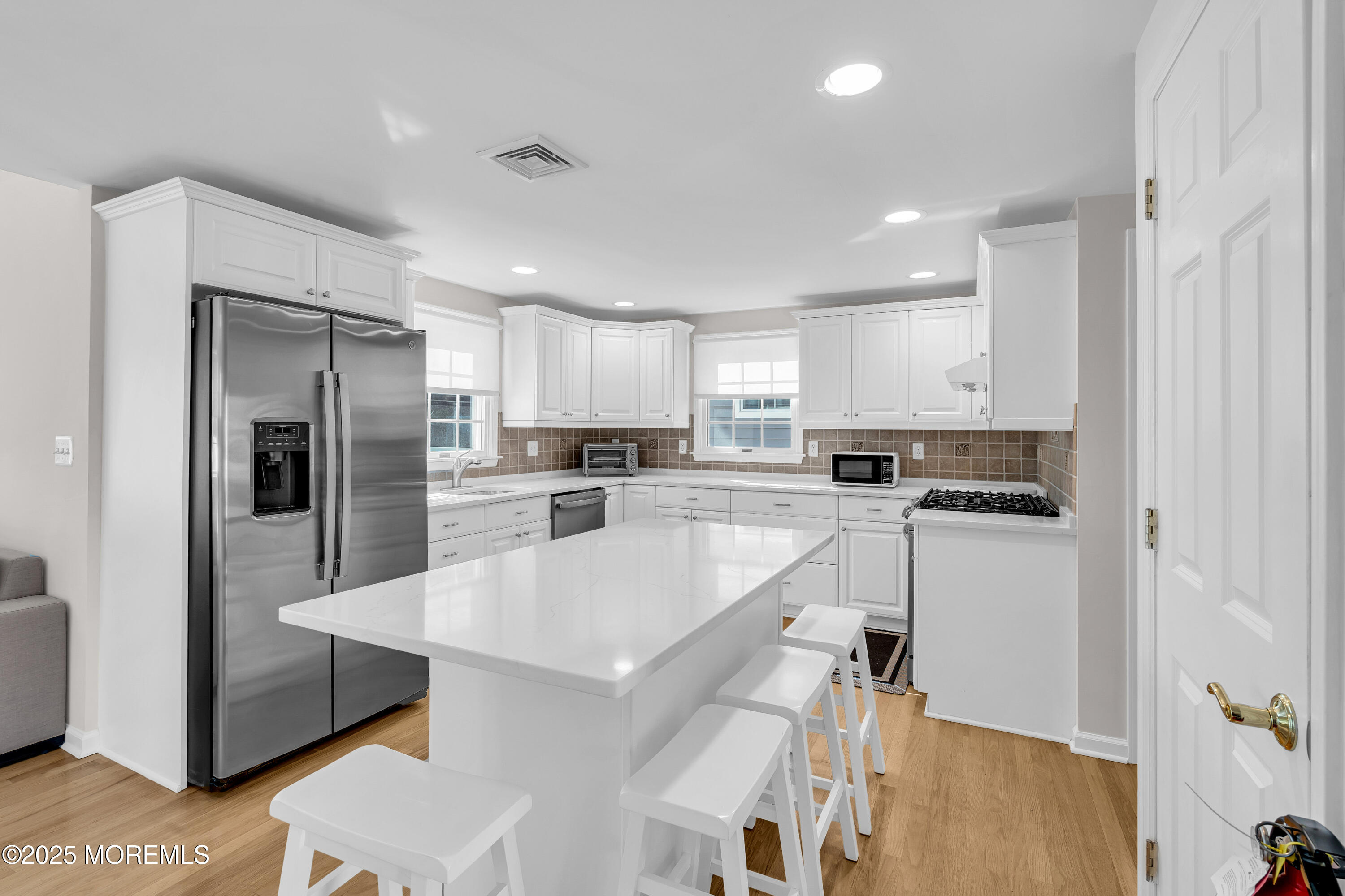 807 Prospect Avenue Spring Lake Heights, NJ 07762 - Photo 6 of 27 a kitchen with a refrigerator a sink and cabinets