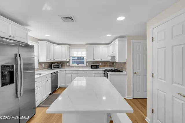 a kitchen with refrigerator and cabinets