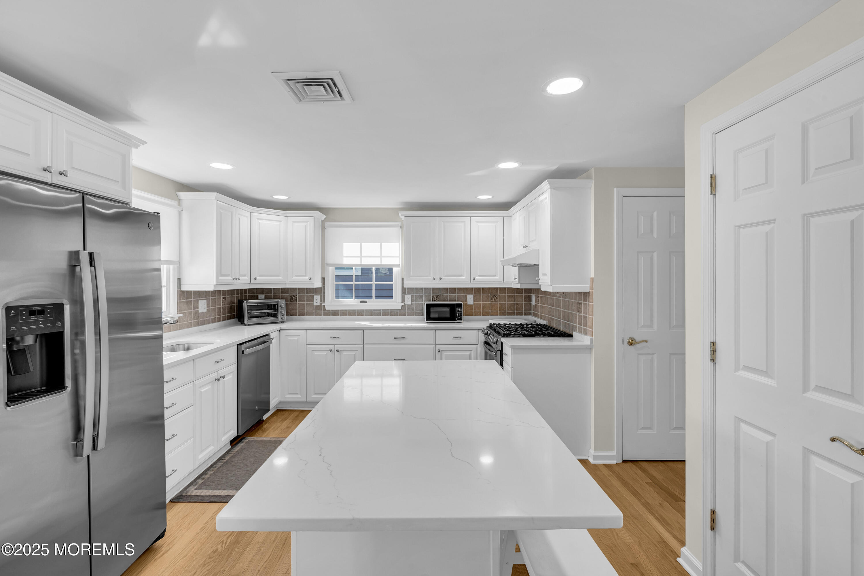 807 Prospect Avenue Spring Lake Heights, NJ 07762 - Photo 7 of 27 a kitchen with refrigerator and cabinets