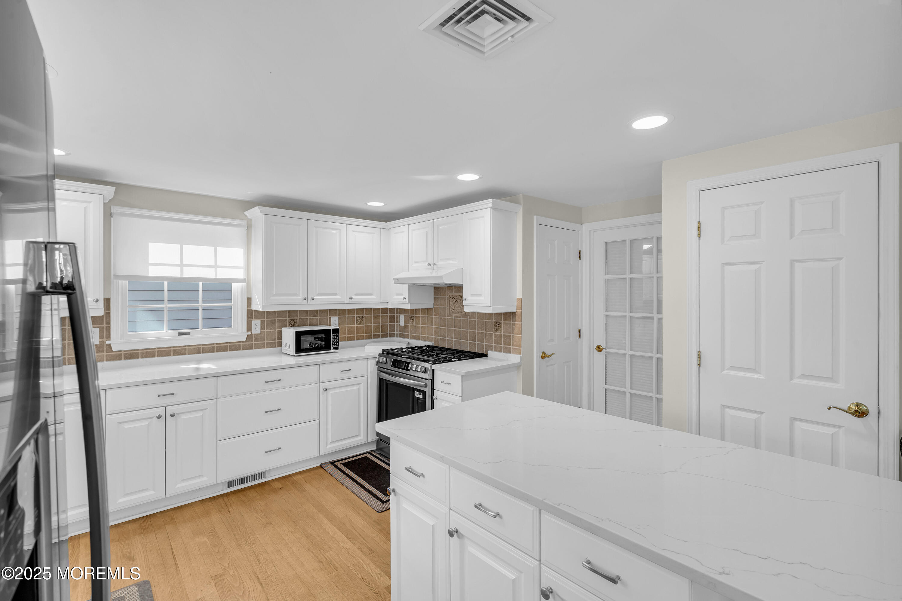 807 Prospect Avenue Spring Lake Heights, NJ 07762 - Photo 9 of 27 a kitchen with white cabinets and sink