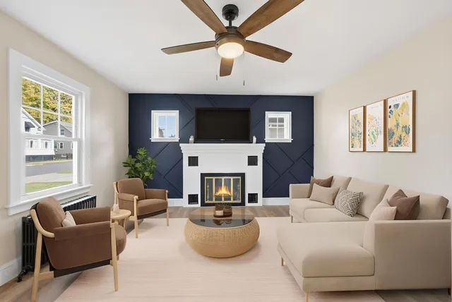 a living room with furniture a fireplace and a flat screen tv