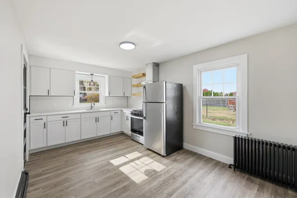 a kitchen with a refrigerator a sink and cabinets