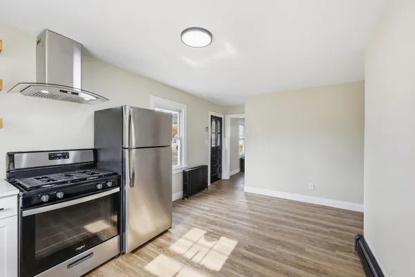 a kitchen with stainless steel appliances a refrigerator and a stove top oven