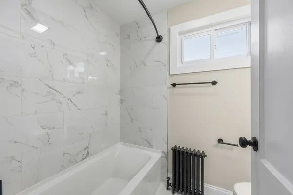 a bathroom with a bathtub and a shower