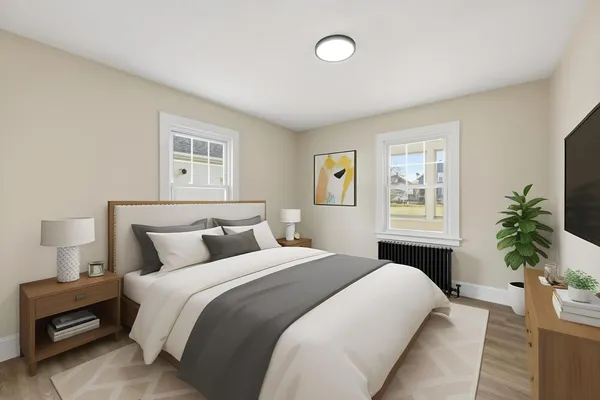 a bedroom with bed and a potted plant