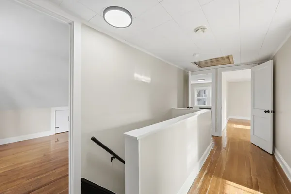 a view of hallway with wooden floor