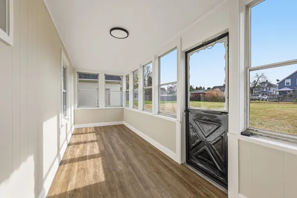 a view of a room with wooden floor and outdoor space