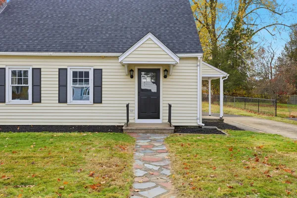 a front view of a house with a yard and porch