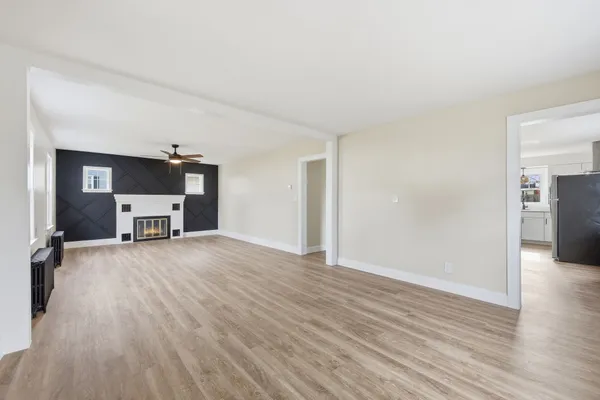 a view of a livingroom with a fireplace and wooden floor
