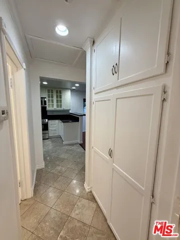 a view of a hallway to rooms and stairs