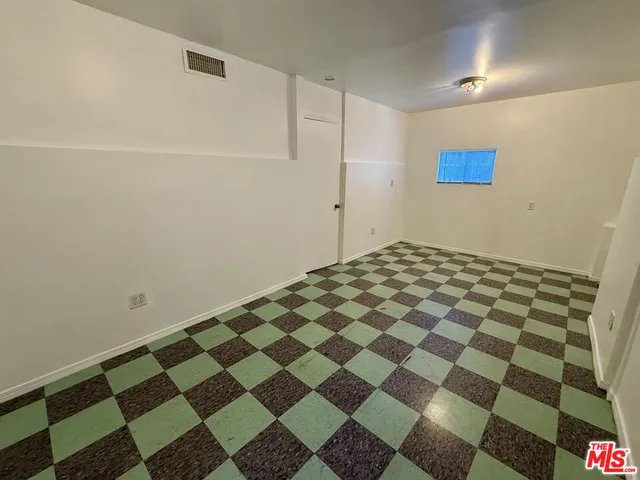 a view of a room with a black white checkered floor