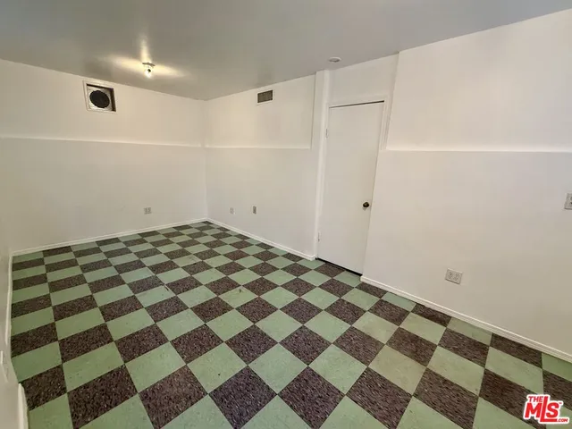 a view of a room with a black white checkered floor