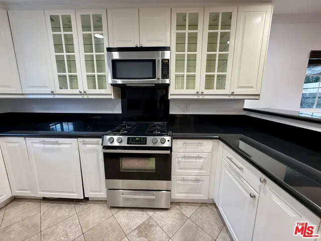 a kitchen with a stove and a microwave