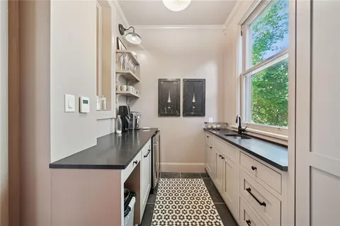 a kitchen with granite countertop a sink stove and cabinets