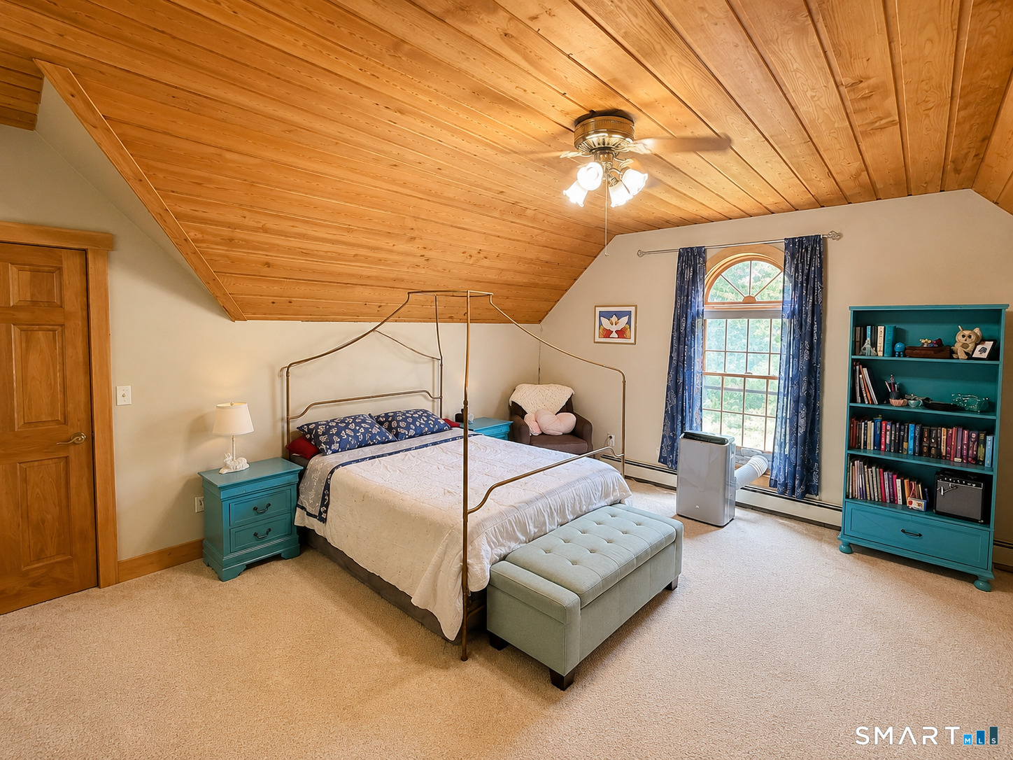 44 Pine Road Colebrook, CT 06021 - Photo 27 of 40 a bedroom with a large bed and a chandelier