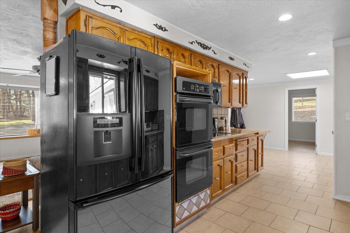 324 China Gulch Road Jacksonville, OR 97530 - Photo 13 of 45 a kitchen with stainless steel appliances granite countertop a refrigerator and a stove