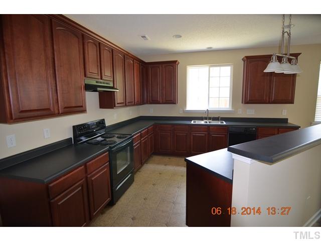 5841 Parkchester Road Raleigh, NC 27616 - Photo 4 of 8 a kitchen with granite countertop stainless steel appliances a sink stove and cabinets