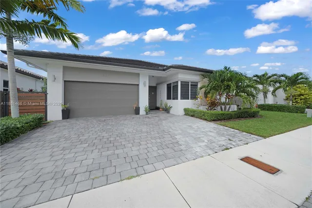 a front view of a house with a yard and a garage