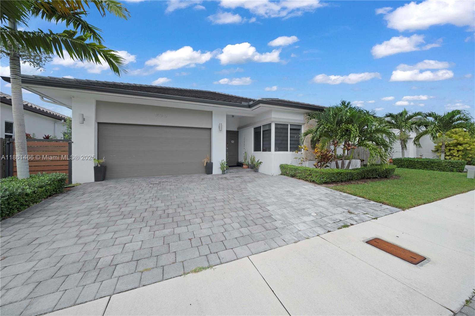 a front view of a house with a yard and a garage