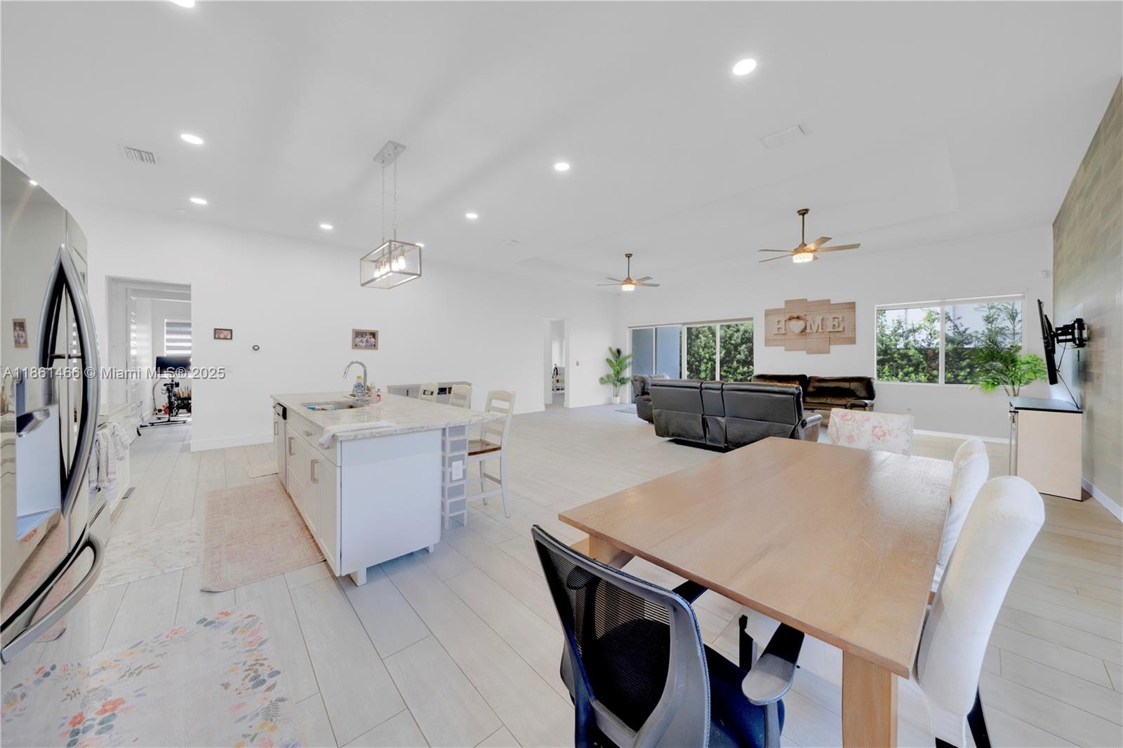 15012 Southwest 177th Terrace Miami, FL 33187 - Photo 11 of 16 a large kitchen with a table and chairs