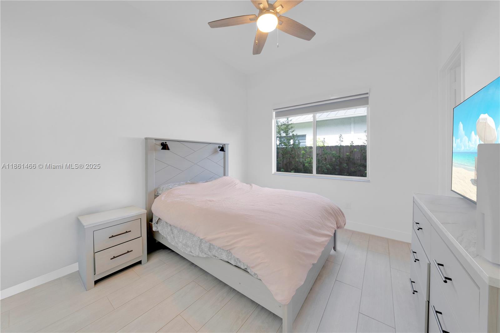 15012 Southwest 177th Terrace Miami, FL 33187 - Photo 12 of 16 a bedroom with a bed and a window