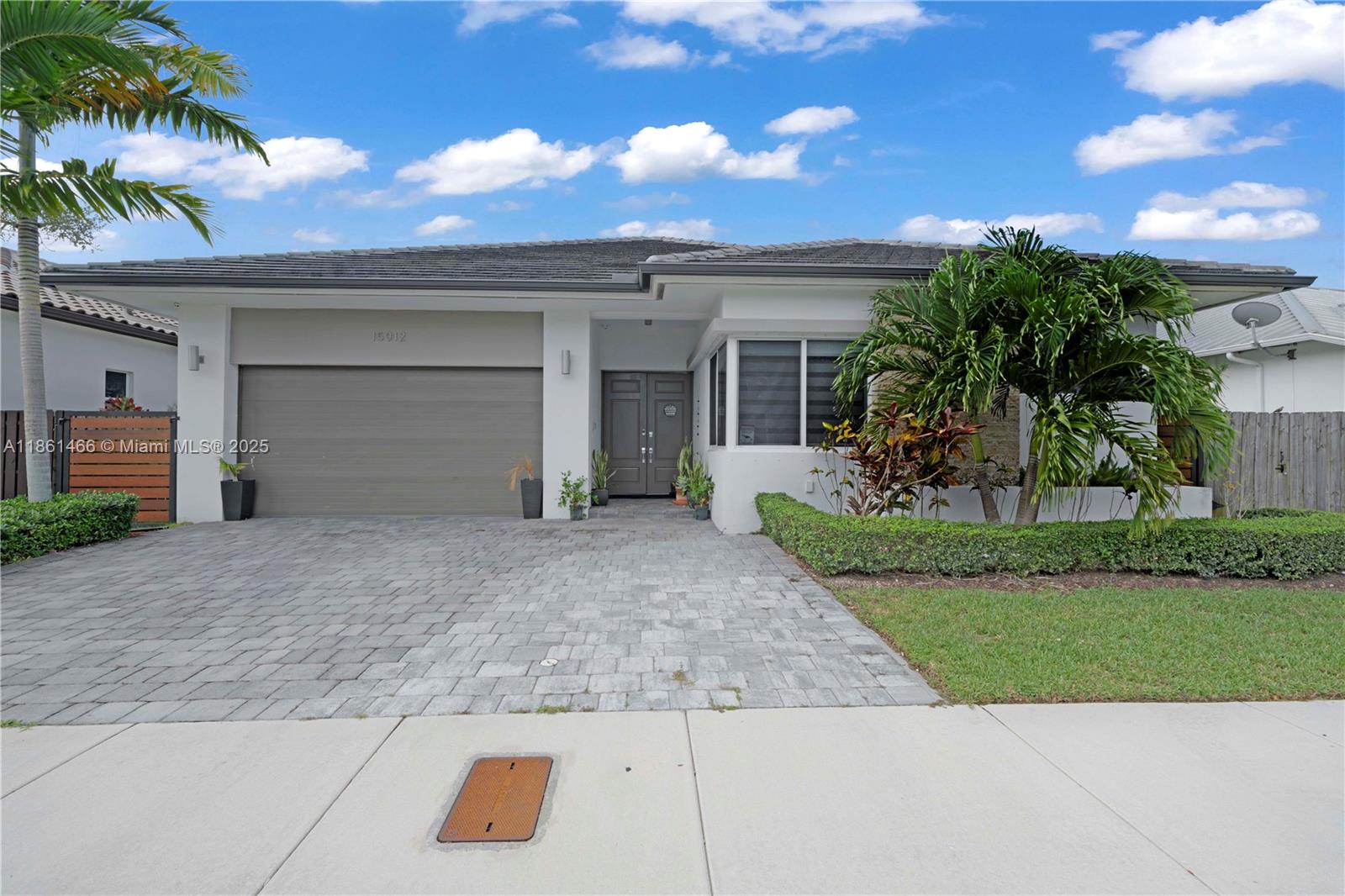15012 Southwest 177th Terrace Miami, FL 33187 - Photo 2 of 16 front view of a house with a yard