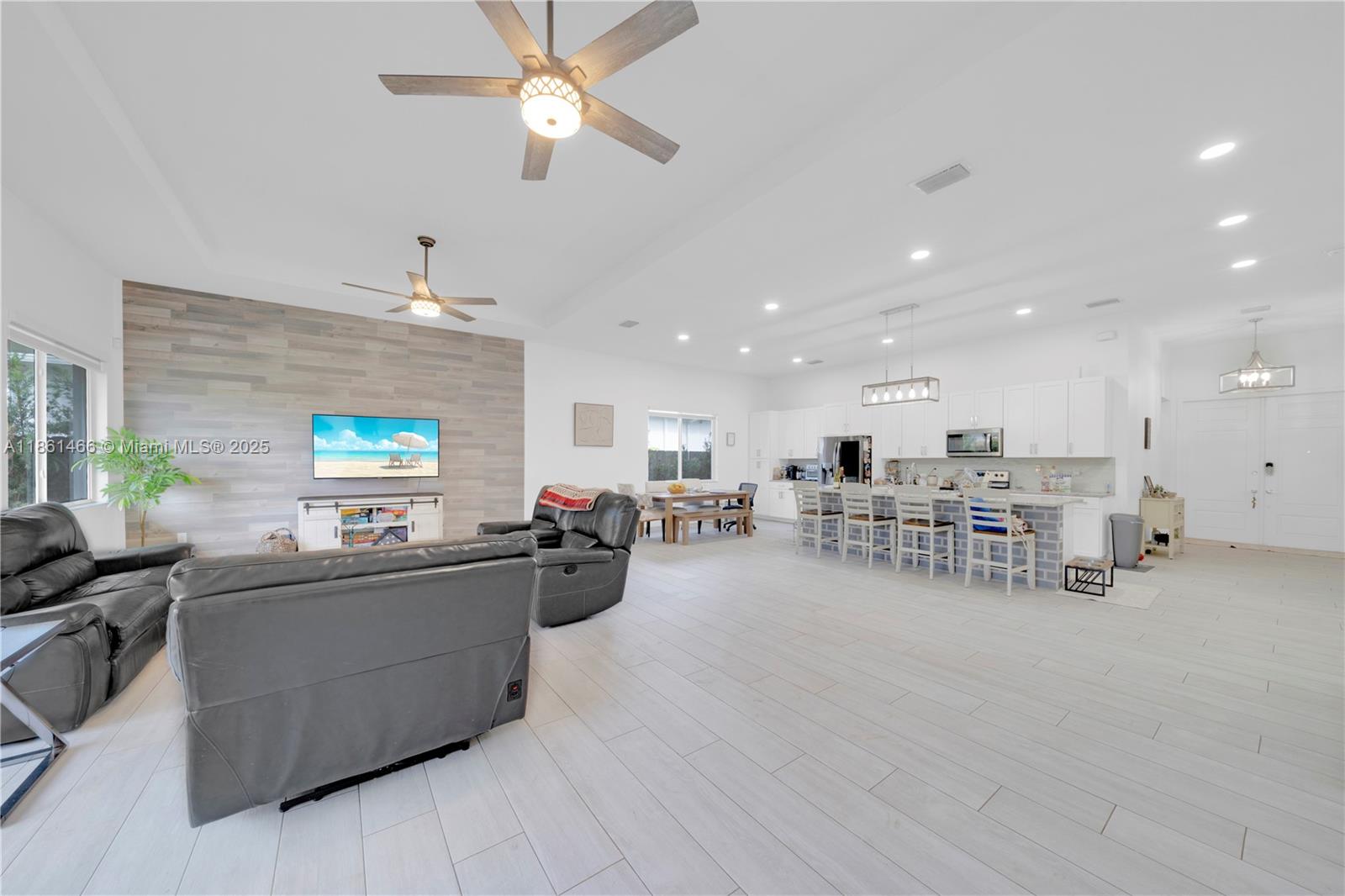 15012 Southwest 177th Terrace Miami, FL 33187 - Photo 3 of 16 a living room with furniture and a flat screen tv