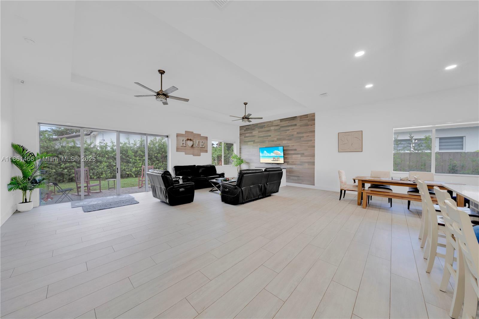 15012 Southwest 177th Terrace Miami, FL 33187 - Photo 5 of 16 a living room with furniture and a large window