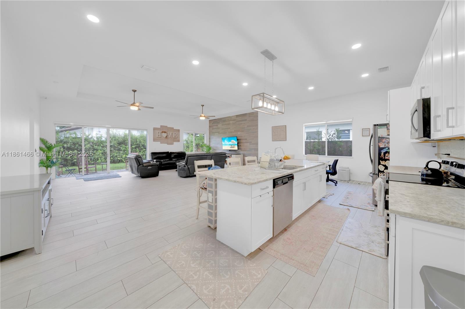 15012 Southwest 177th Terrace Miami, FL 33187 - Photo 9 of 16 a large white kitchen with lots of counter space and windows