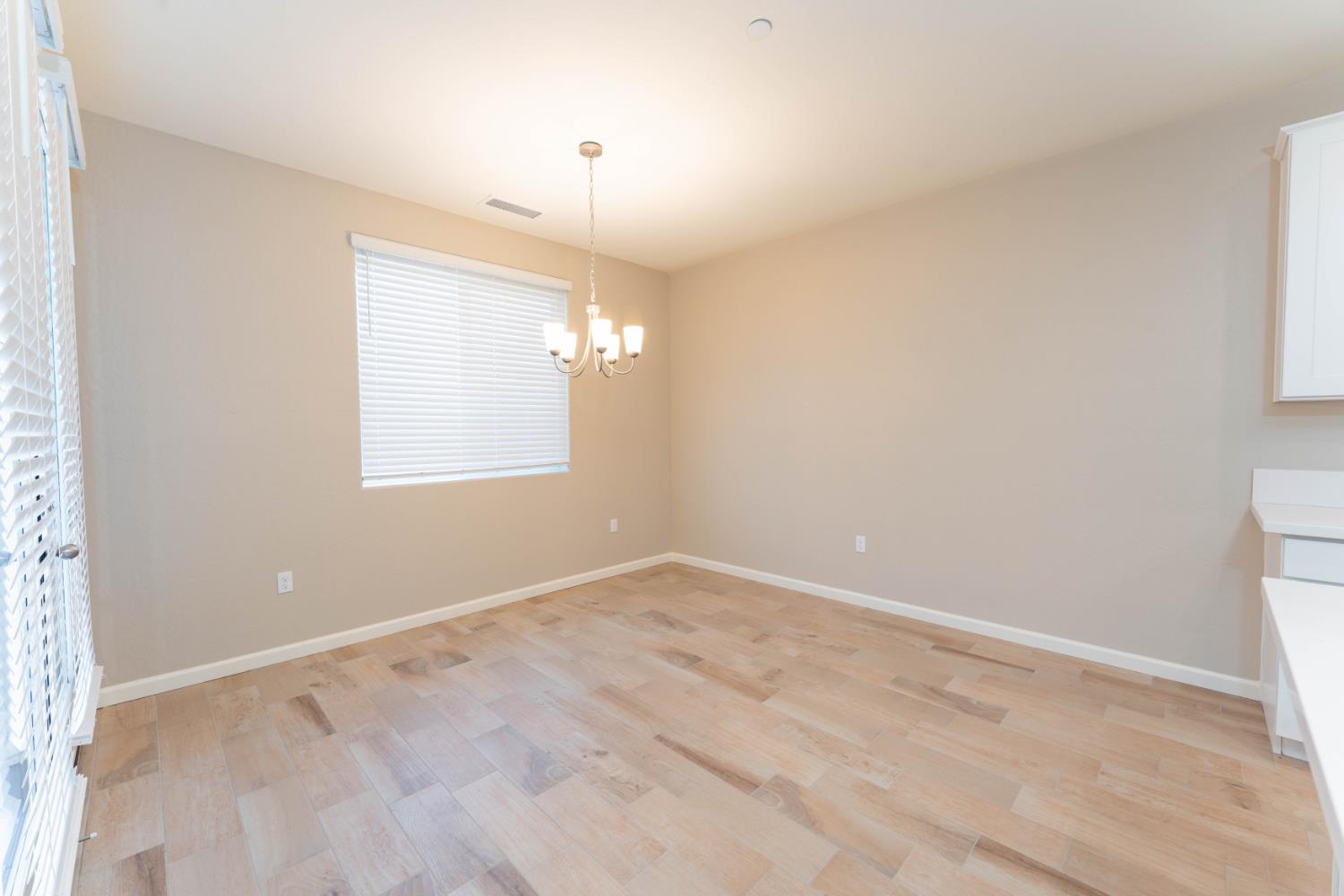 30480 Bellwood Road Visalia, CA 93291 - Photo 8 of 37 an empty room with chandelier fan and windows