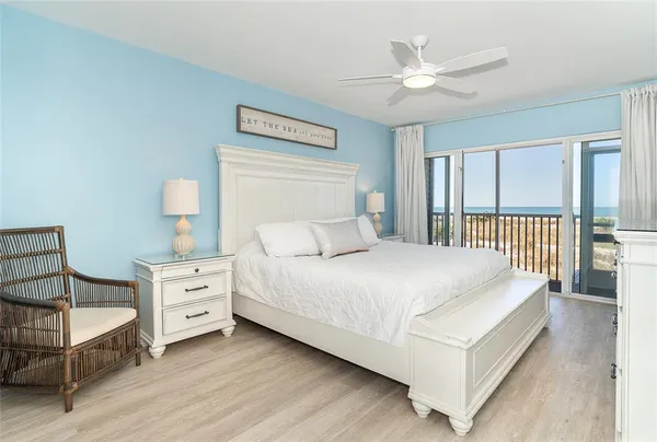 a bedroom with a bed a window and a chandelier