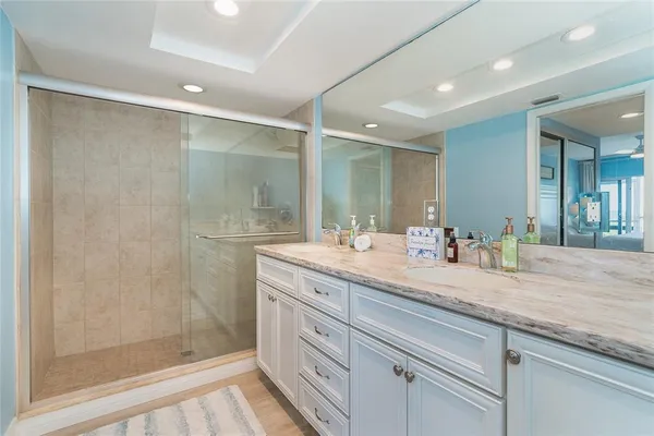 a bathroom with a granite countertop sink mirror and double