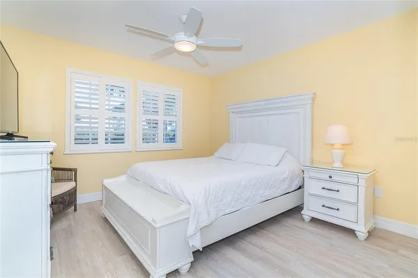 a bedroom with a large bed and a chandelier