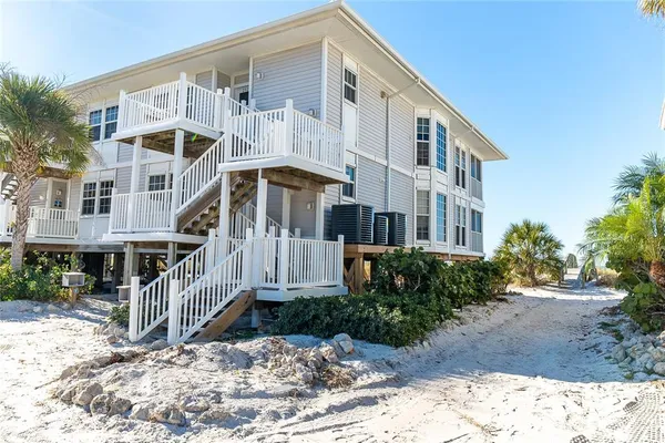 a front view of a house with a yard and balcony