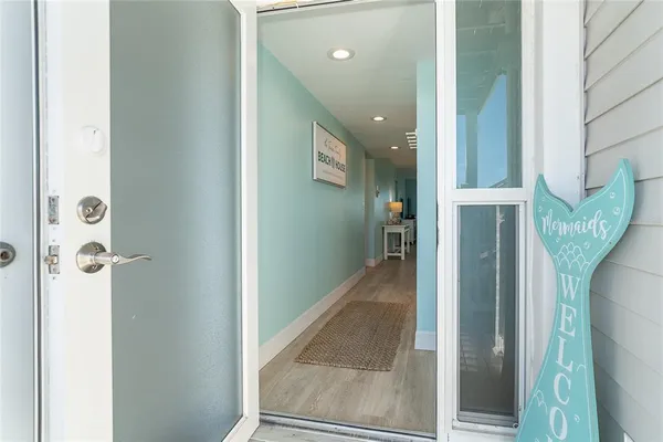 a view of a hallway with wooden floor and entryway
